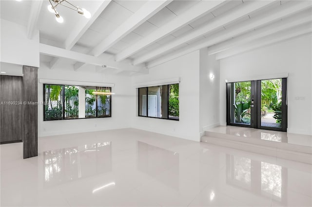 unfurnished living room with tile patterned floors, lofted ceiling with beams, a chandelier, and french doors