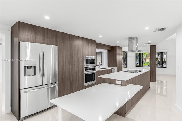 kitchen featuring a kitchen island, sink, appliances with stainless steel finishes, and island range hood