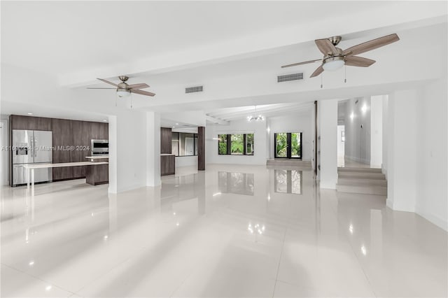 unfurnished living room featuring vaulted ceiling with beams, ceiling fan, and light tile patterned floors