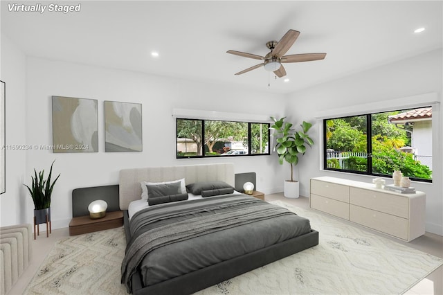 bedroom featuring ceiling fan and multiple windows