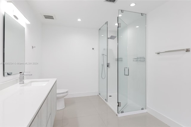 bathroom featuring tile patterned floors, vanity, toilet, and an enclosed shower