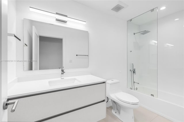 full bathroom with tile patterned flooring, vanity, toilet, and enclosed tub / shower combo