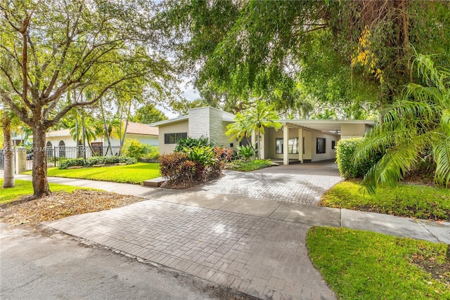 view of front facade with a carport and a front yard