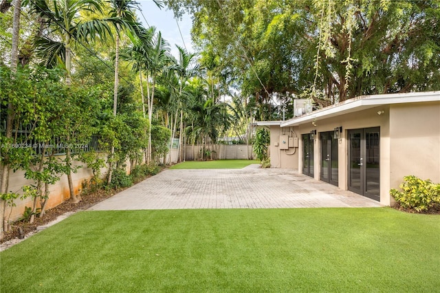 view of yard featuring french doors and a patio