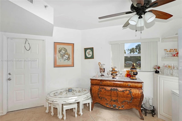 living area featuring ceiling fan and light tile patterned floors