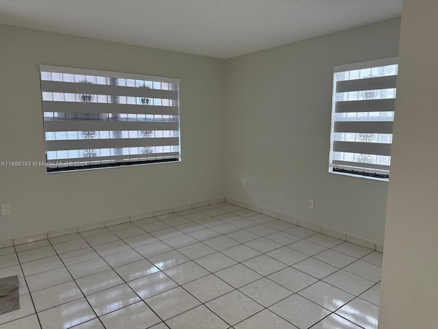 unfurnished room featuring light tile patterned floors