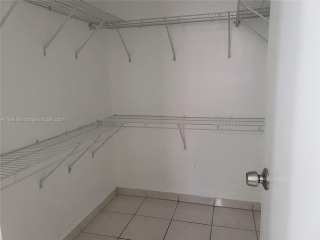 spacious closet featuring light tile patterned flooring