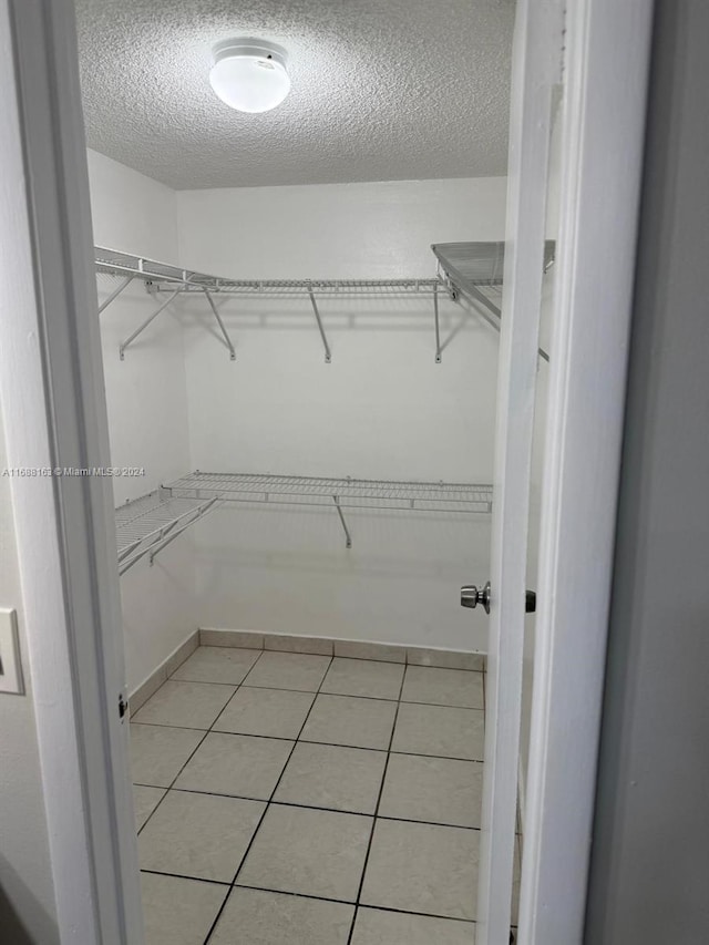 walk in closet featuring light tile patterned floors