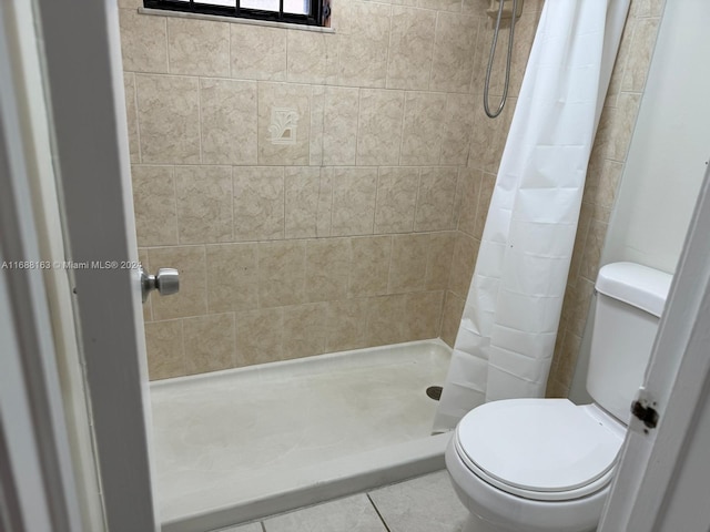 bathroom with toilet, tile patterned flooring, and a shower with shower curtain