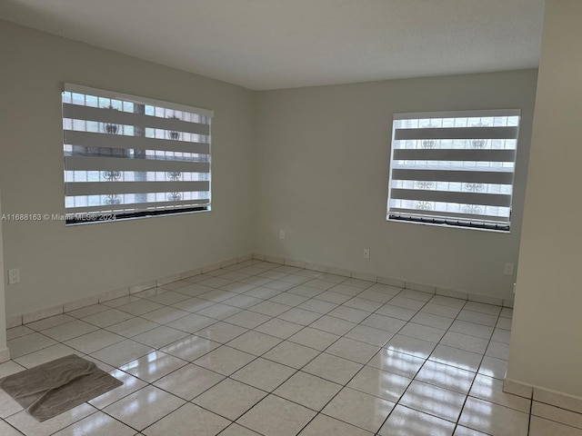 empty room with light tile patterned floors