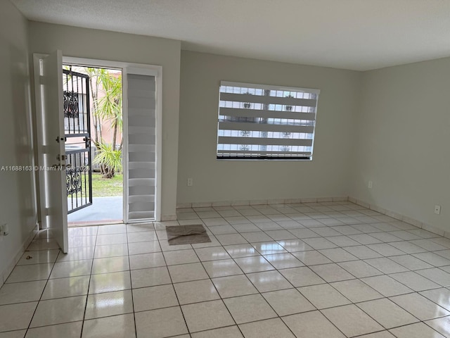 entrance foyer featuring light tile patterned floors and a textured ceiling