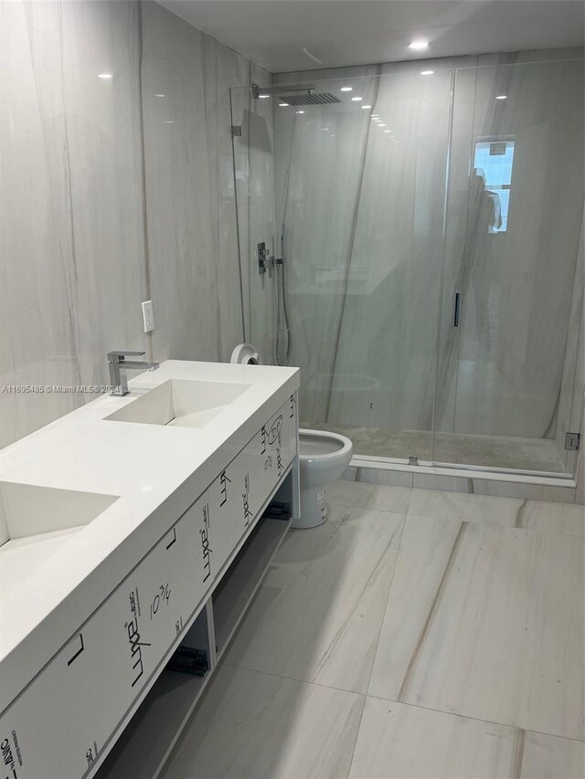 bathroom featuring vanity, toilet, and walk in shower