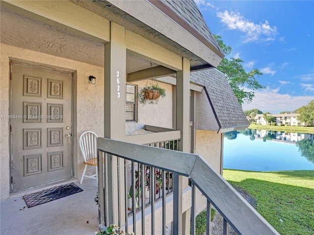 doorway to property featuring a water view and a balcony