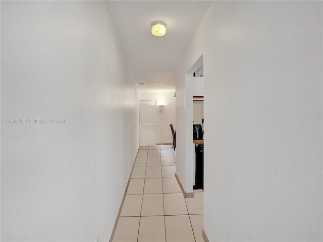 hall with light tile patterned floors