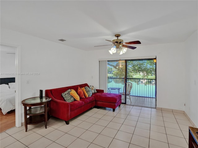 tiled living room featuring ceiling fan