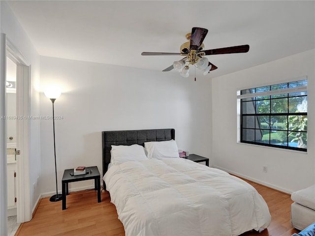 bedroom with light hardwood / wood-style flooring and ceiling fan