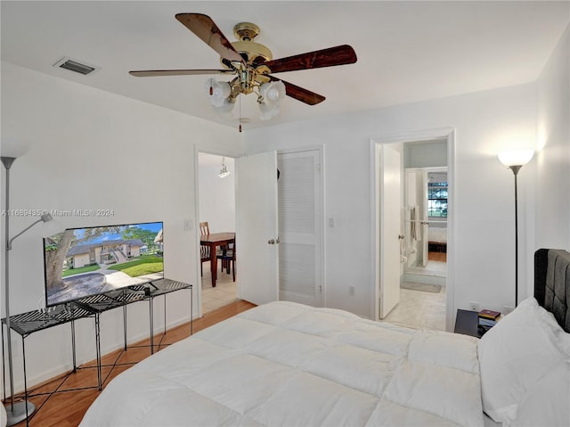 bedroom featuring ensuite bath, ceiling fan, and light hardwood / wood-style flooring