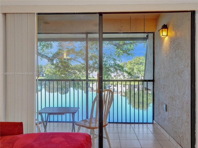 sunroom featuring a water view