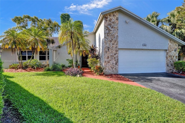 view of front of home featuring a front lawn and a garage