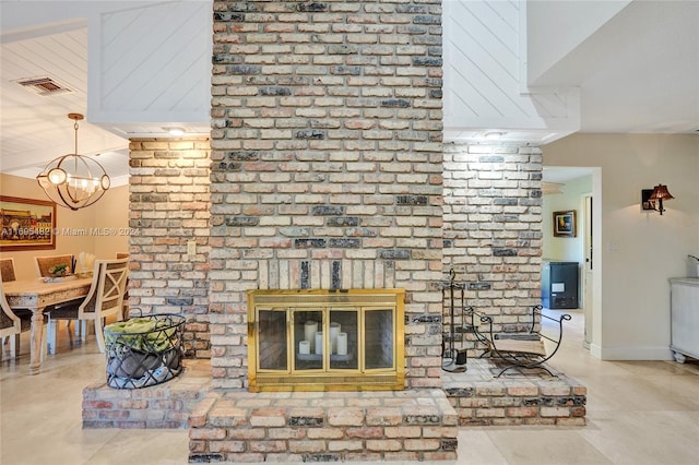 living room with a fireplace, a chandelier, and vaulted ceiling