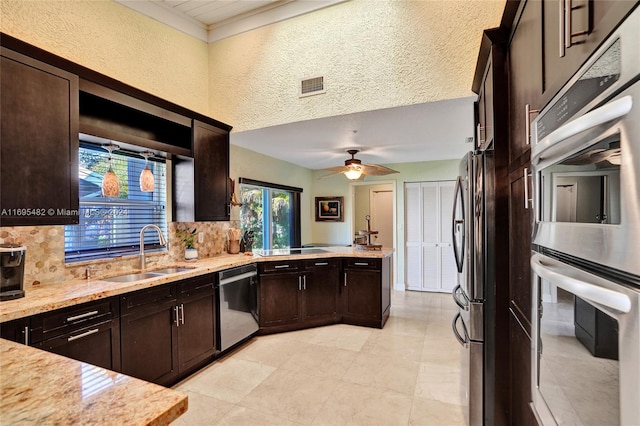 kitchen featuring ceiling fan, sink, a textured ceiling, and appliances with stainless steel finishes