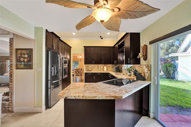 kitchen featuring kitchen peninsula, backsplash, dark brown cabinetry, stainless steel appliances, and ceiling fan