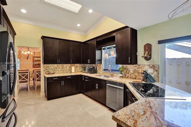 kitchen featuring a healthy amount of sunlight, lofted ceiling with skylight, sink, and appliances with stainless steel finishes