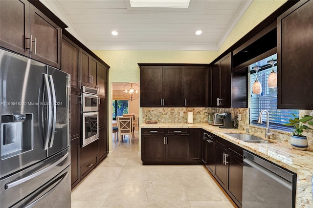 kitchen featuring backsplash, dark brown cabinetry, sink, and appliances with stainless steel finishes