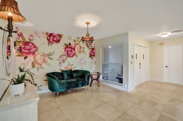 unfurnished room with a chandelier and a textured ceiling