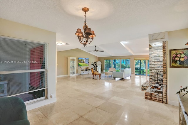 living room featuring a textured ceiling, ceiling fan with notable chandelier, and lofted ceiling