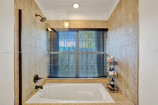 bathroom with tiled shower / bath combo and crown molding