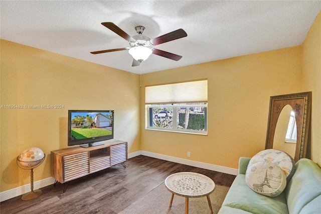 living room with ceiling fan, hardwood / wood-style floors, and a textured ceiling