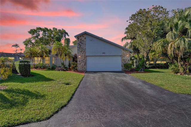 view of front facade featuring a lawn and a garage