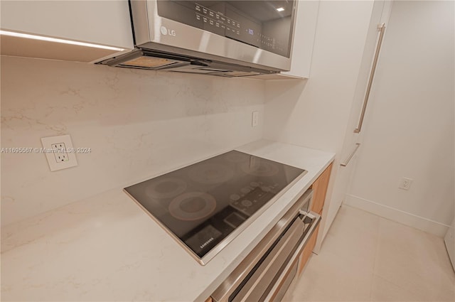 kitchen featuring white cabinets and appliances with stainless steel finishes