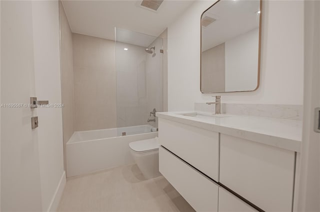 full bathroom featuring vanity, toilet, and tiled shower / bath