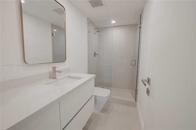 bathroom featuring vanity, an enclosed shower, and toilet