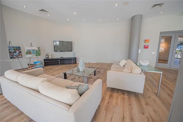 living room with french doors and light hardwood / wood-style flooring