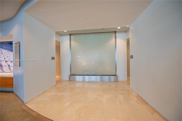 corridor featuring light tile patterned flooring