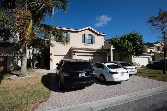 mediterranean / spanish-style home featuring a garage and a front lawn