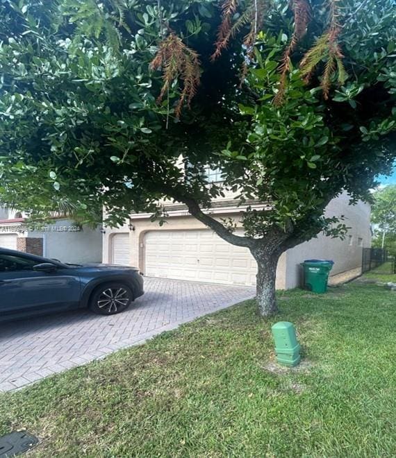 view of home's exterior with a lawn and a garage