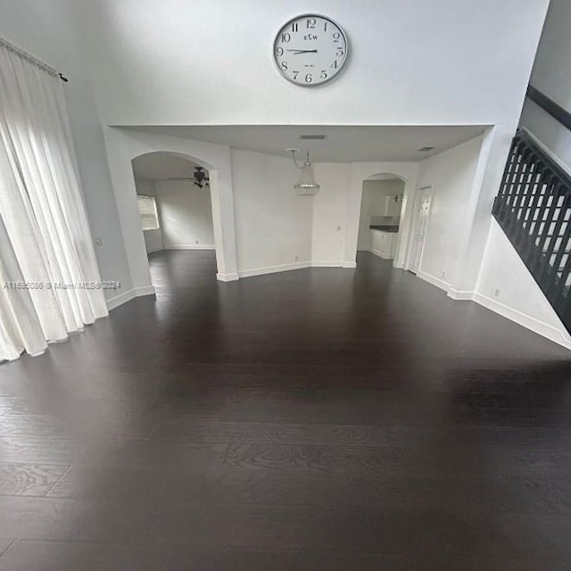 empty room with dark hardwood / wood-style flooring and ceiling fan