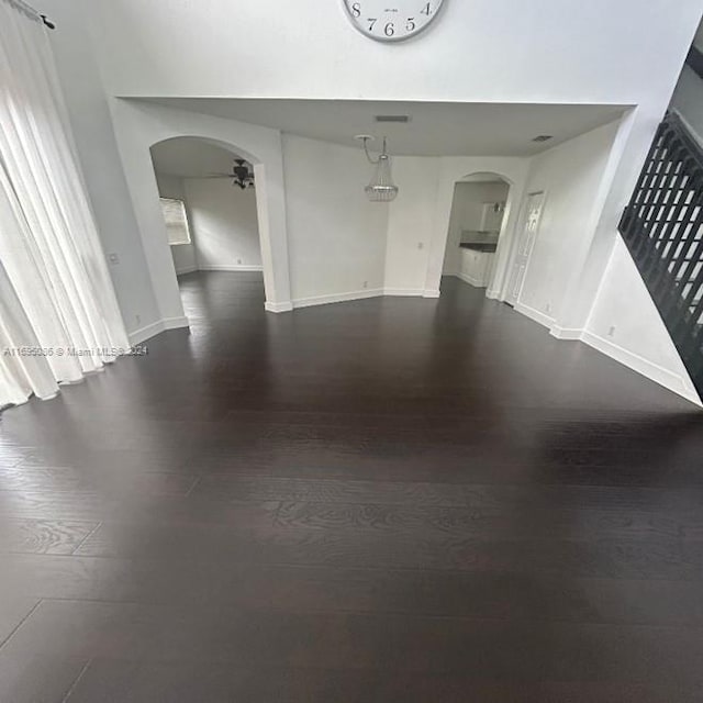 spare room featuring ceiling fan and dark hardwood / wood-style flooring