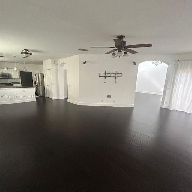 empty room featuring ceiling fan and dark hardwood / wood-style flooring