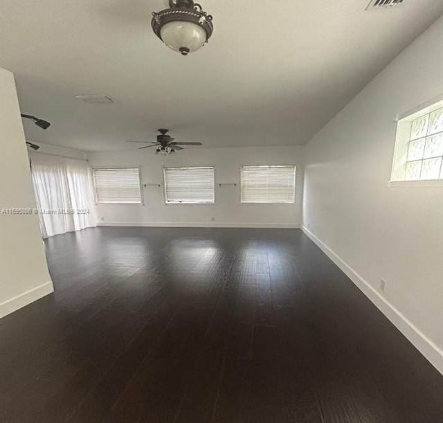 empty room featuring ceiling fan and dark hardwood / wood-style floors