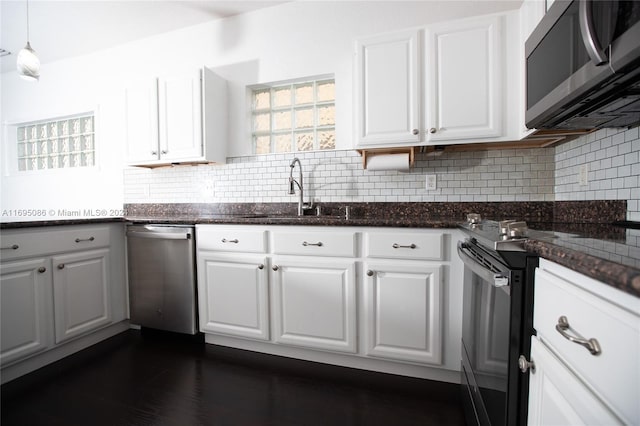 kitchen featuring appliances with stainless steel finishes, white cabinetry, and sink