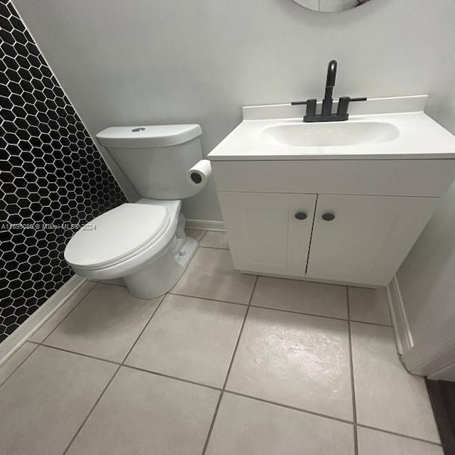 bathroom featuring a shower, tile patterned floors, vanity, and toilet