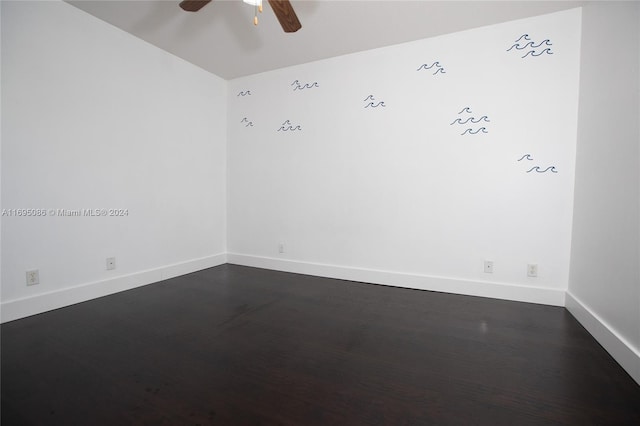 empty room featuring ceiling fan and dark hardwood / wood-style flooring