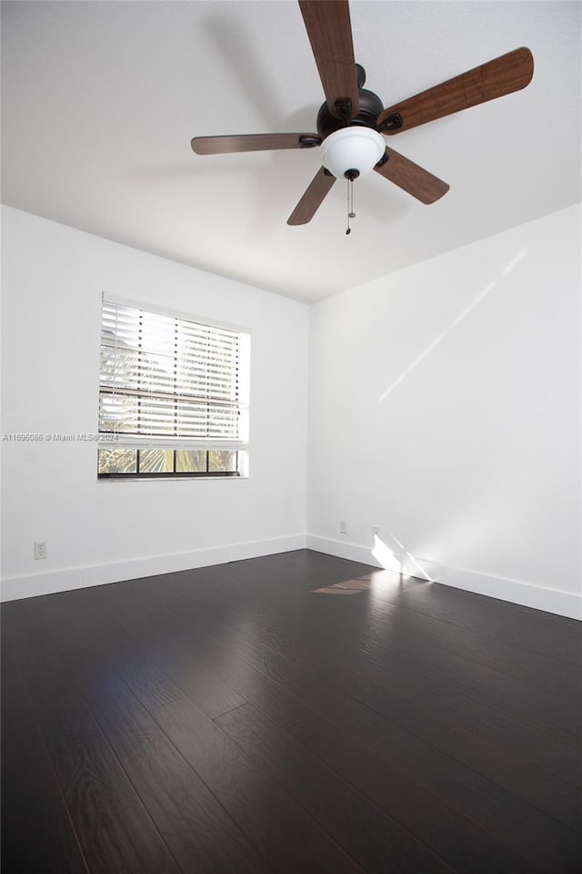 spare room with ceiling fan and wood-type flooring