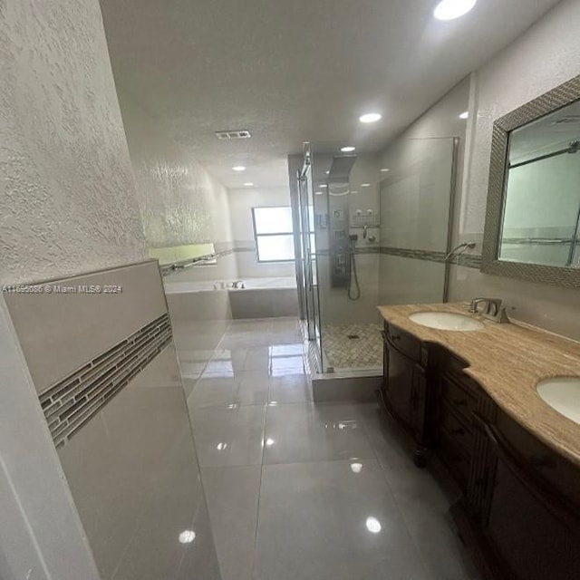 bathroom with separate shower and tub, tile patterned flooring, and vanity