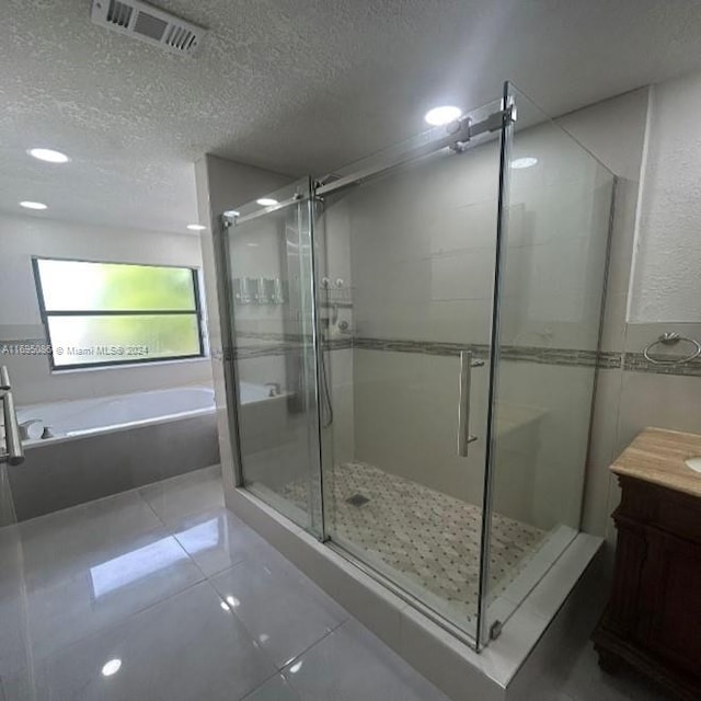 bathroom with tile patterned flooring, vanity, and independent shower and bath